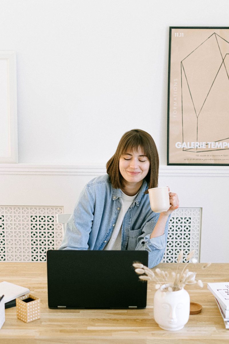 Woman with coffee at her laptop